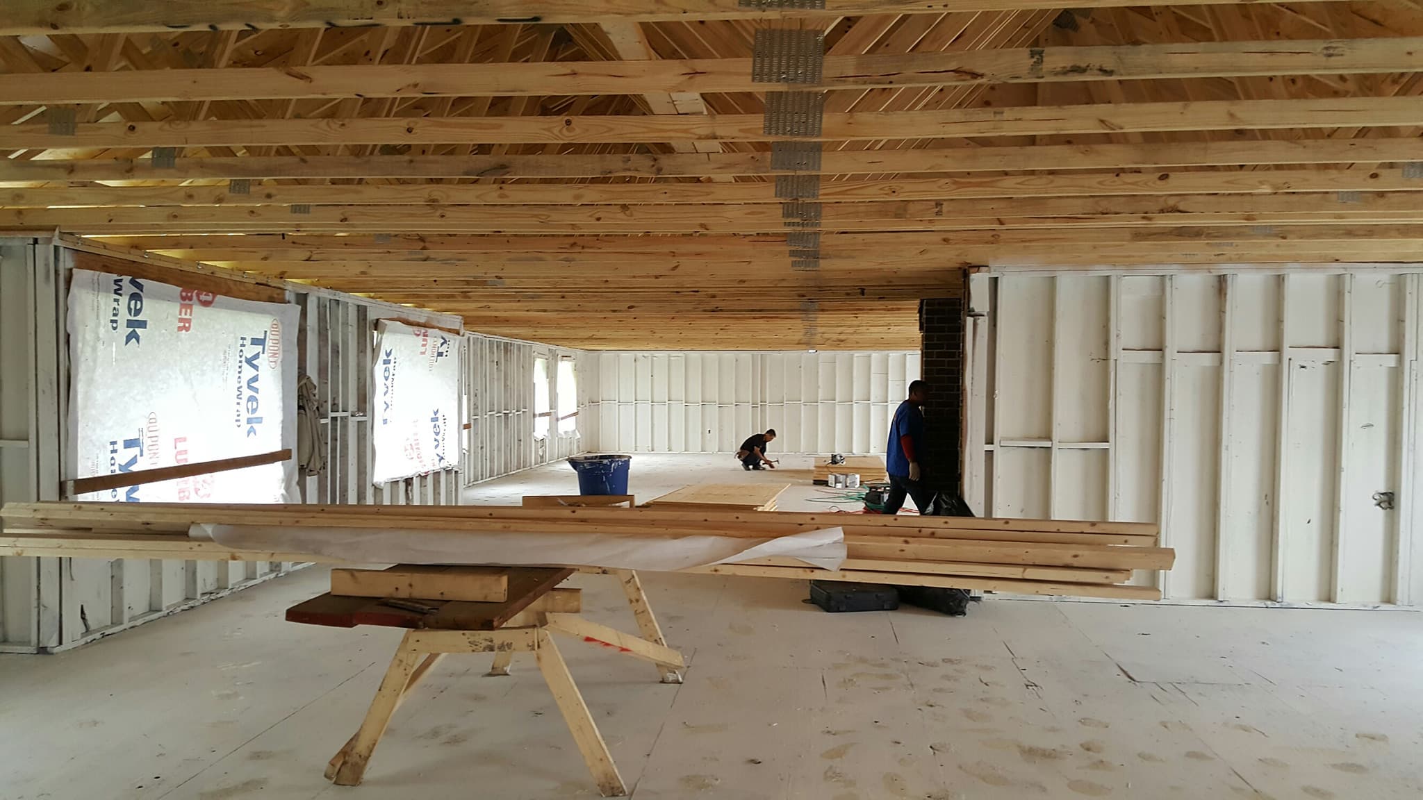 Workers rebuilding a large structure