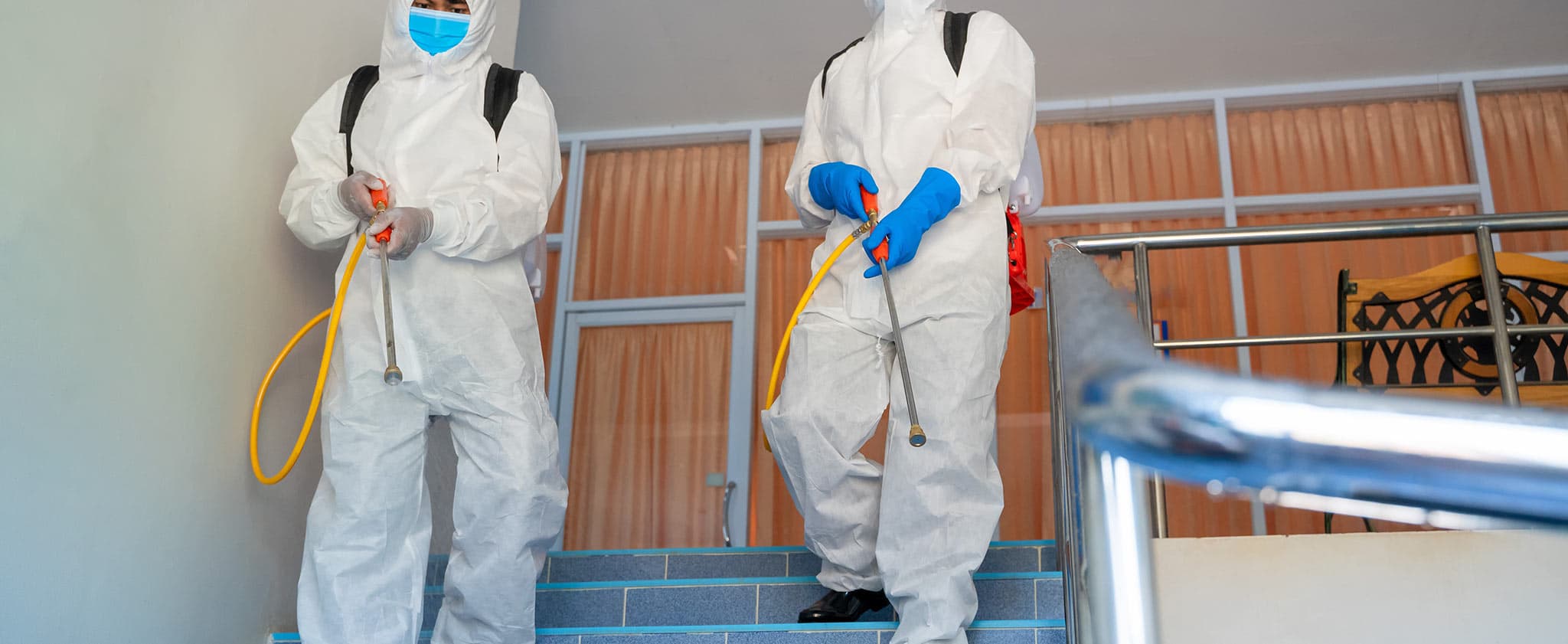 Two workers wearing personal protective equipment (PPE)